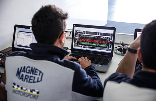 Man typing on computer at Triumph ECU testing for Moto2 engine